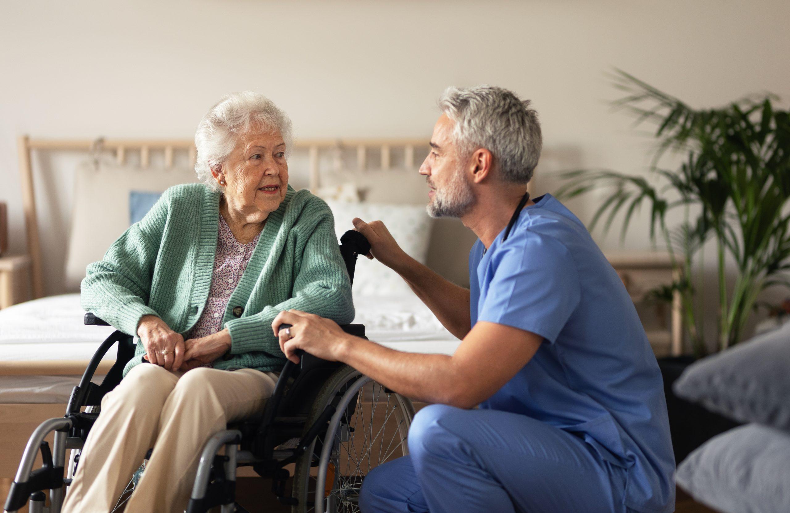 Caregiver doing regular check-up of senior woman