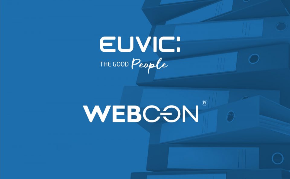 Logo Euvic i Webcon, w tle stos segregatorów